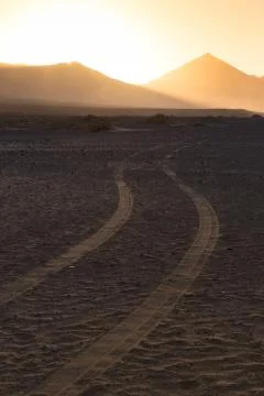 Wheel tracks in sand in dramatic landscape. 스톡 사진