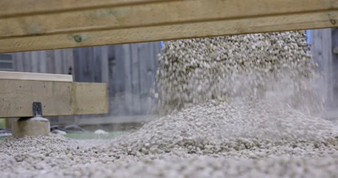 Wheelbarrow dumping rock aggregate to build deck - slow motion Stock Footage 140625387