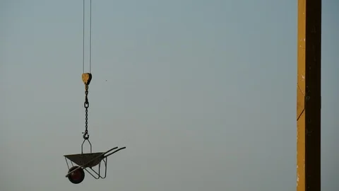 Wheelbarrow hanging on a crane. Video stock 99546204