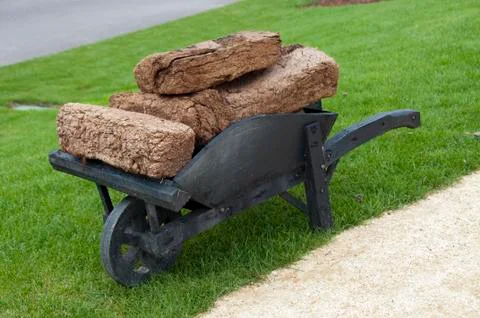 Wheelbarrow with peat Stock Photos