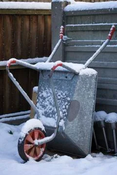Wheelbarrow in snow Stock Photos