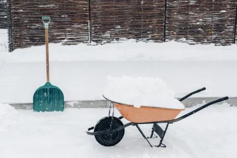Wheelbarrow with snow Stock Photos