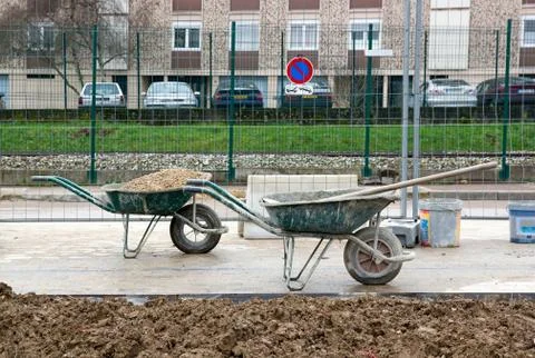 Wheelbarrows in wait of use, construction sites in a city Stock Photos