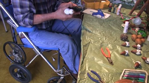 A wheelchair bound man makes another ornament Video stock 45165141