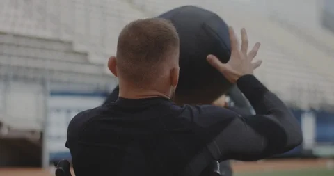 Wheelchaired athlete and trainer throwing medicine ball Stock Footage 116766150