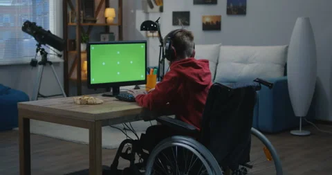 Wheelchaired boy using computer Stock Footage 107434972