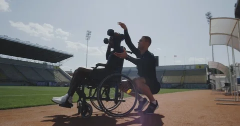 Wheelchaired man doing overhead presses Stock Footage 116766629
