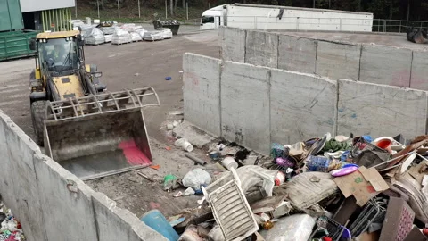 Wheeled loader loading a bucket with garbage at a landfill, close up shot Stock Footage 234192104