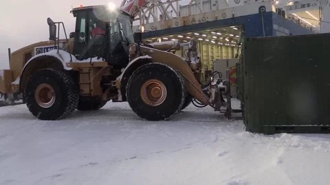 Wheeled loader loading steel container during snowfall Stock Footage 265154514
