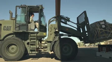 Wheeled loader moving pallet of cargo Stock Footage 85840243