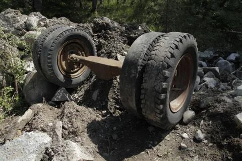 Wheels abandoned on axel in dump. Stock Photos