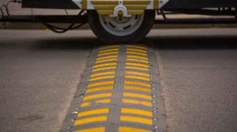 Wheels and Speed Bump on the Road. HD 1080p. Stock Footage 41278729