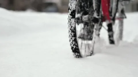The wheels of a bicycle that rides through deep, freshly fallen snow Stock Footage 263577223