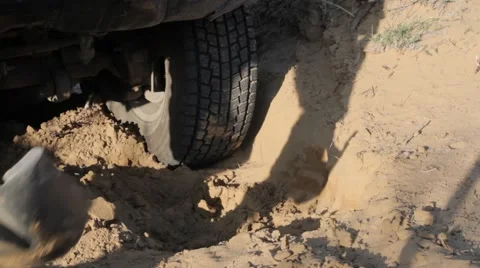 Wheels car stalled in the sandy soil, dig with a shovel Stock Footage 61748007