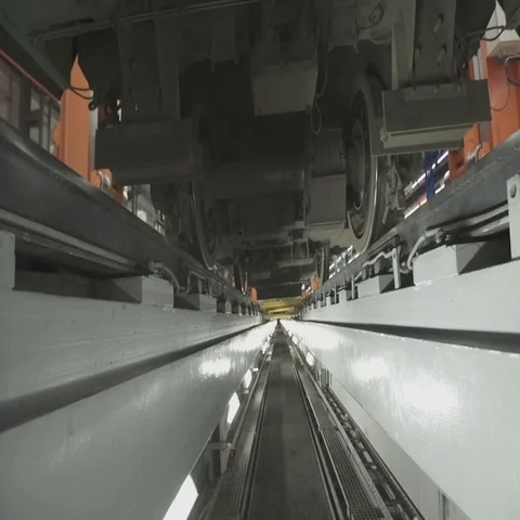 Wheels on chassis of train wagons at workshop in factory Stock Footage 69482146