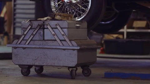 Wheels of the Classic Car Lifted Down On a Lift. Car Ready to Restore Stock Footage