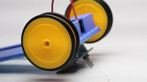 Wheels connected to dc motor shaft tested with motor controller Stock Footage 339017778