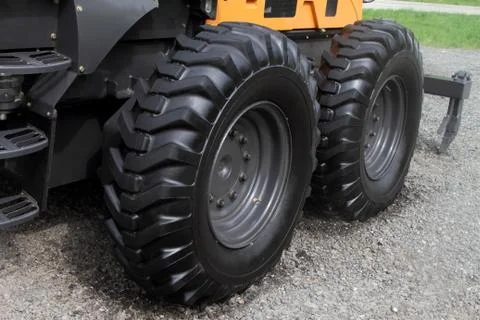 Wheels with a high protector of tractor. Stock Photos