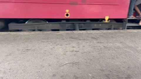 Wheels of a moving train. People standing on foot board dangerous Stock Footage 203993268
