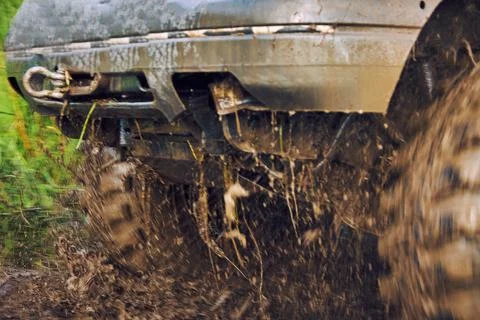 Wheels of the offroader slide through the mud, the car is stuck on the off-road Stock Photos