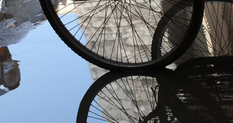 Wheels reflection on road in rain water Stock Footage 324499600