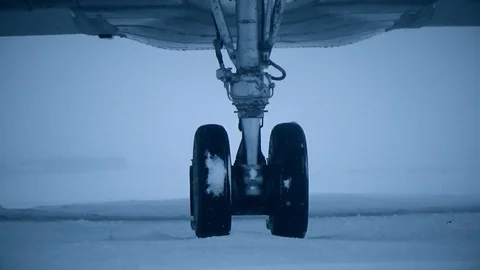 The wheels of the snow-covered plane Video stock 108371396