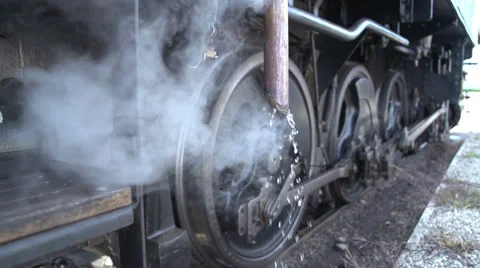 Wheels of steel. steam engine train locomotive. smoke puffing. slow motion Stockbeeldmateriaal 34542504