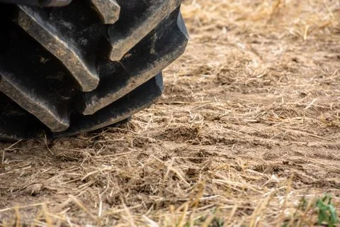 Wheels of tractor plowing field Stock Photos
