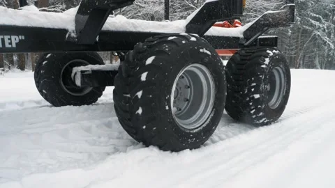 Wheels from a trailer for loading logs close-up in a snowy forest Stock Footage 169548692
