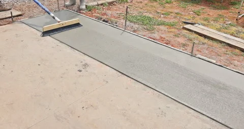 When construction worker uses broom brushing pattern textured to freshly Stock Footage 276139250