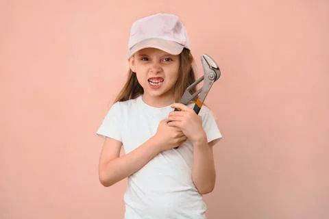 When dad wanted a son, but he is raising a daughter. Girl tomboy with a wrench Stock Photos