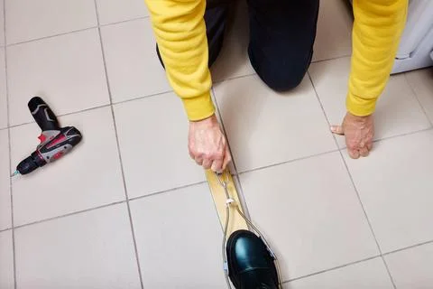 When installing cable ski bindings on wooden skis, installer adjusts tensio.. Stock Photos