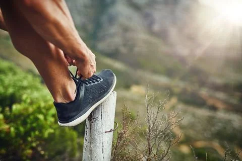 When it comes to running, your shoes must be secure. an unrecognizable man Stock Photos