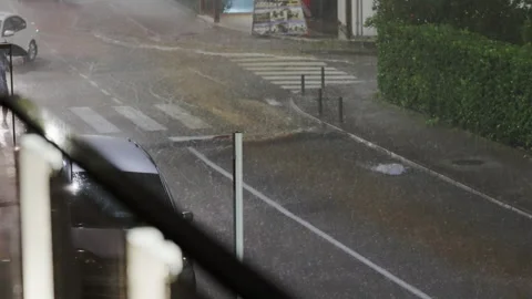 When it rains, various objects float along the roads of the city at night Stock Footage 255499084