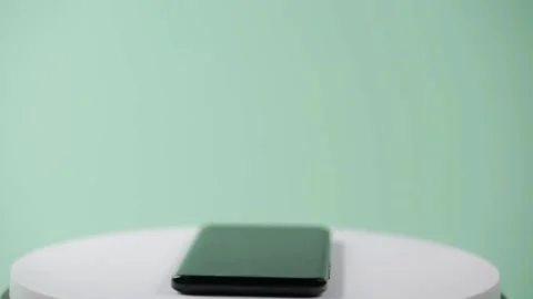 When the phone is turned off, it rotates on a green background Stock Footage 150449865
