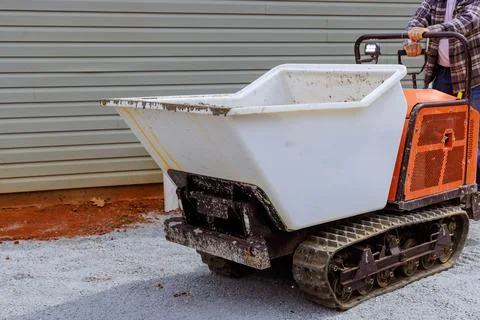 When pouring concrete, workers use dumper tracked a wheelbarrows Stock Photos