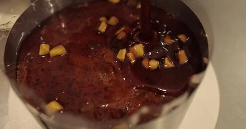 When preparing a chocolate cake by a professional confectioner, the process.. Stock Photos