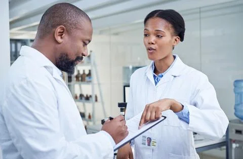 When a problem arises, they hop right on solving it. two scientists having a Foto stock