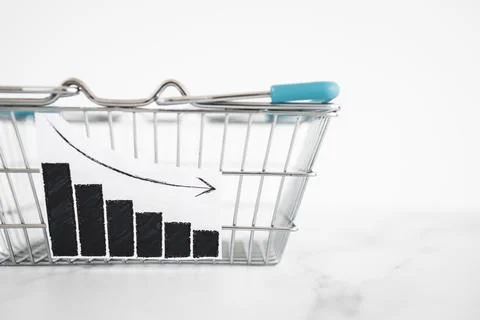 When will inflation go down. shopping basket with graph showing prices drop.. Stock Photos