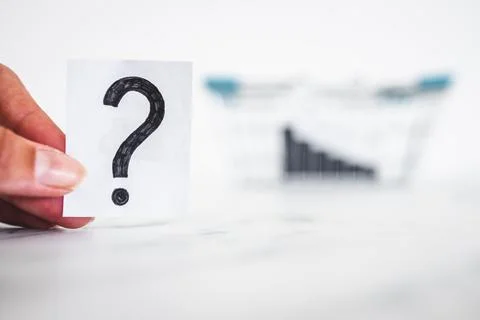 When will inflation go down. shopping basket with graph showing prices drop.. Stock Photos