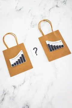 When will inflation go down. shopping bags with graph showing prices increa.. Stock Photos