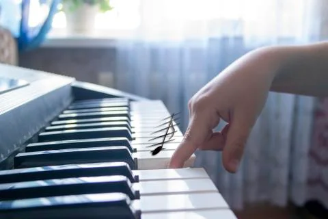 When you tap a note on a musical instrument with your finger it appears in th Stock Photos