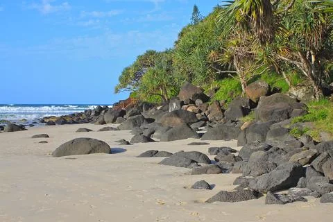 Where beach meets rocks Stock Photos
