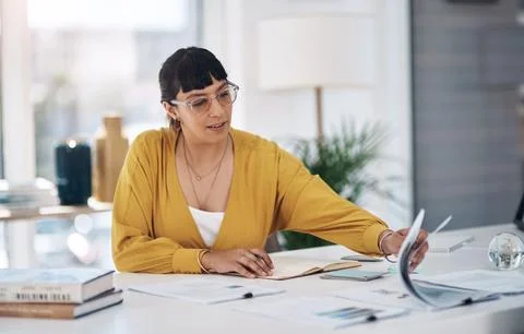 Where did I put that document. an attractive young businesswoman sitting alone Stock Photos