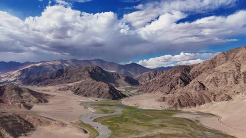 Where mountain winds kiss flowing streams—Ladakh’s green heart revealed- Aerial Stock Footage 310899360