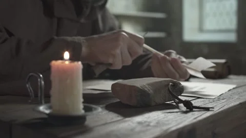 Whetstone with a monk sharpening a penknife in the background Stock Footage 338994505
