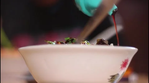 While adding soy sauce to the chicken noodles. Stock Footage 270441848