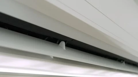 While the air conditioner creates a pleasant indoor climate. Stock Footage 315542490