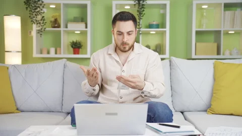 While calculating the household budget, the young man gets angry  Stock Footage 231010647