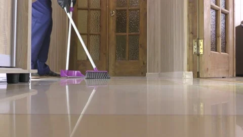 While cleaning with a scoop and brush in the hallway. Stock Footage 150084854